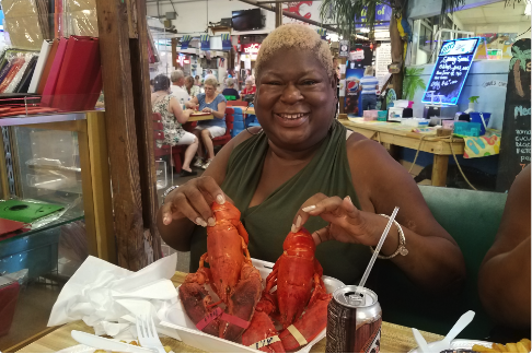 Advocates in Action - Woman smiling eating lobster